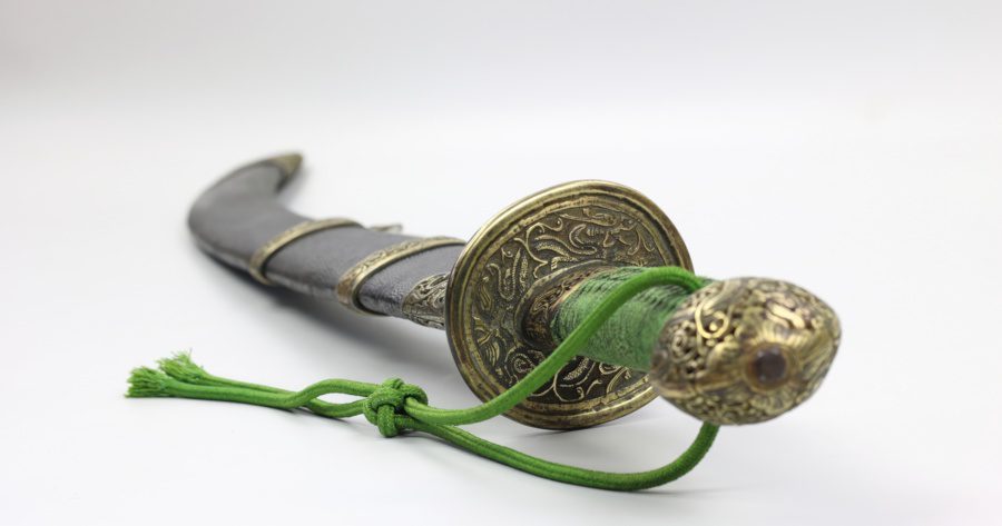 A carved brass saber guard on a 19th century Qing officers saber