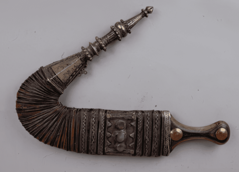 Steel dagger jambiya with a carved wooden hilt