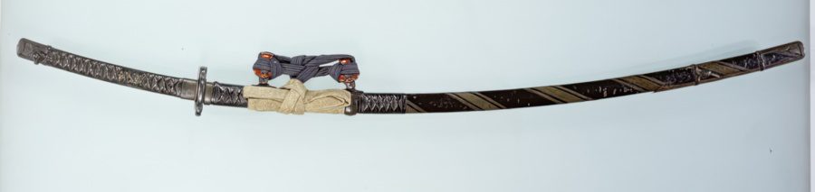 Long sword with black lacquered mountings wreathed with silver and bronze strips