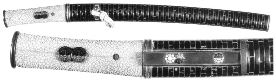 dashi menuki on the unwrapped hilt of a Japanese sword
